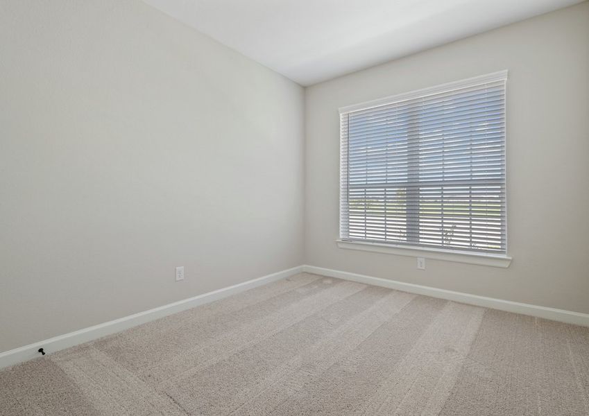Secondary bedroom with lush carpet flooring