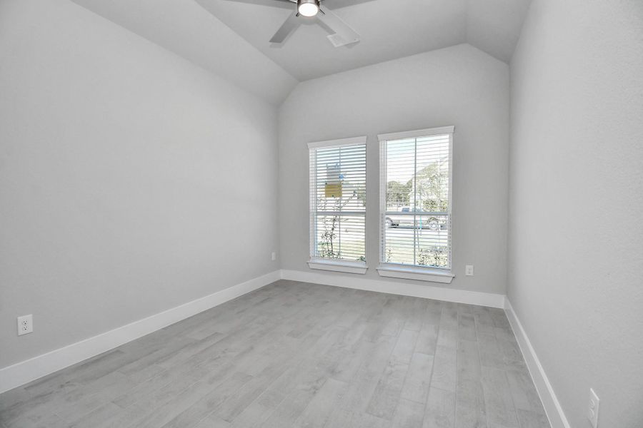 Step into the inviting home office, where elegant tile flooring adds a touch of freshness and comfort to the workspace. Natural light pours through the window, creating an inspiring environment for productivity and focus. Sample photo of completed home with similar floor plan. Actual colors and selections may vary.