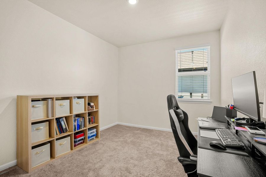 A well-lit room offers a versatile space for an office or study.