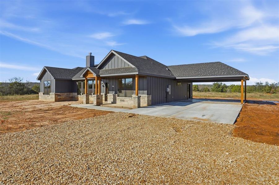 View of front of house featuring board and batten siding, a shingled roof, a chimney, a porch, and driveway View of front of house featuring board and batten siding, a shingled roof, a chimney, a porch, and driveway