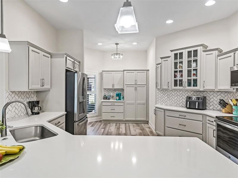 Kitchen with quartz counter tops and Marble backsplash in herringbone pattern