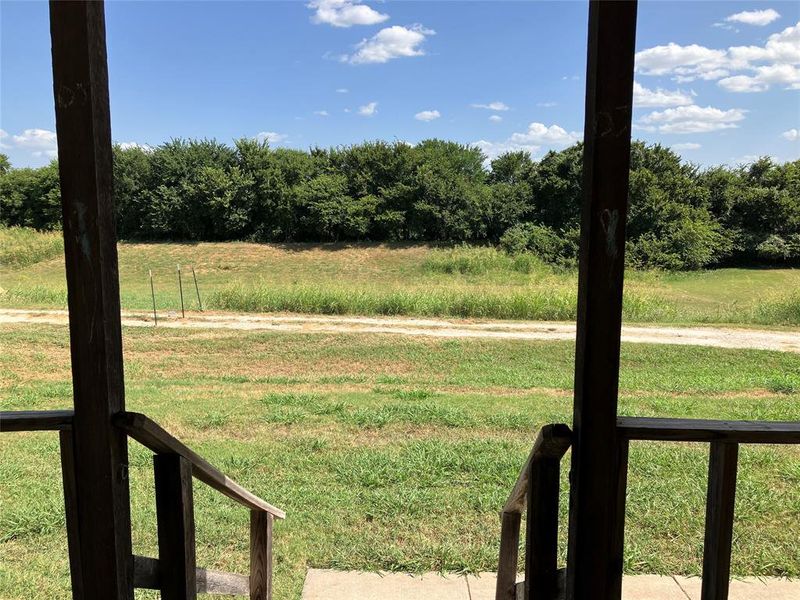 View of yard. Property extends into the tree line