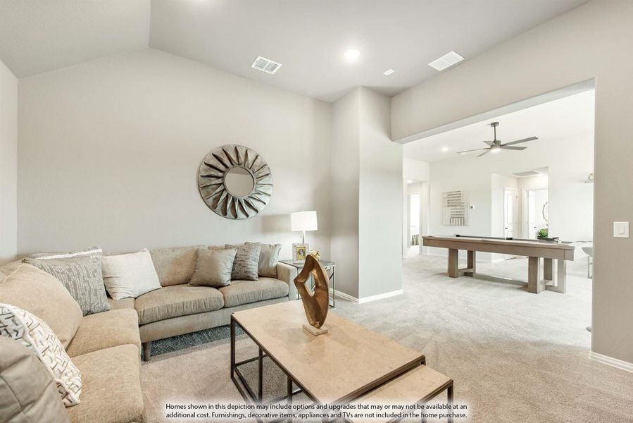 Living room with beige sectional sofa and high ceilings, open to game room with pool table and ceiling fan