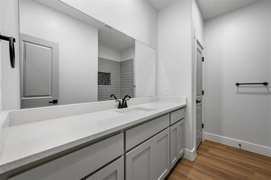 Bathroom with vanity and hardwood / wood-style flooring