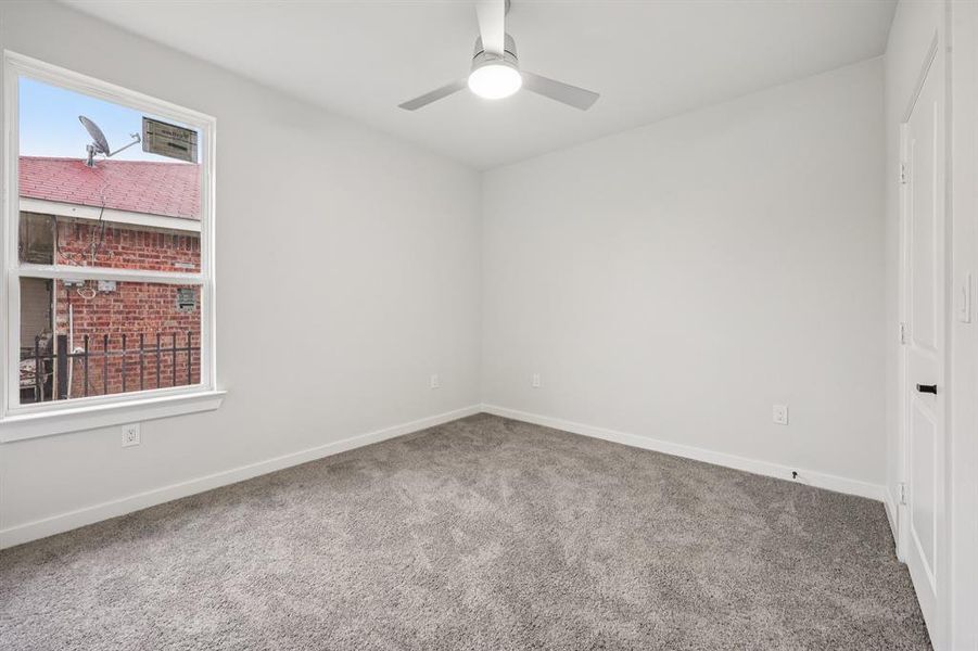 Carpeted empty room featuring a ceiling fan and baseboards Carpeted empty room featuring a ceiling fan and baseboards