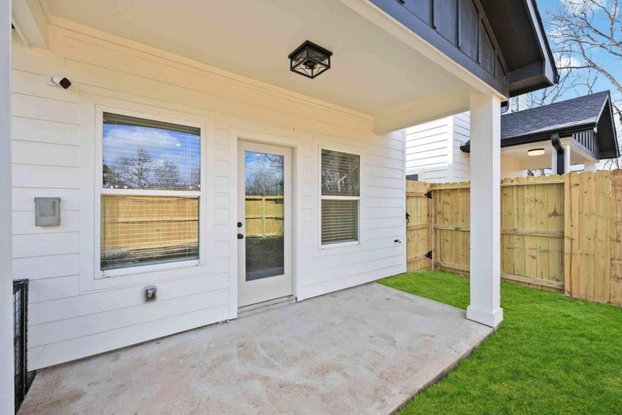 Fully fenced backyard with green space and room for pets, play, or future landscaping.