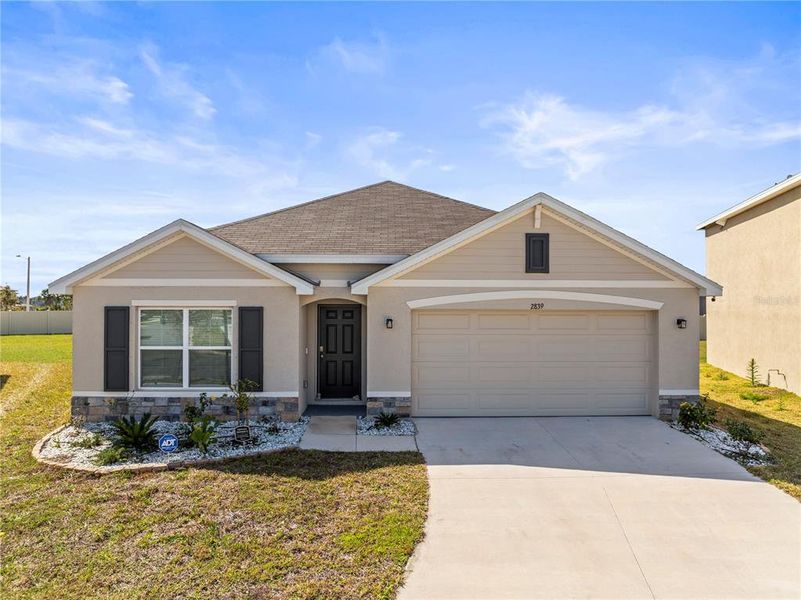 Front exterior of a new home in Berry Bay, Wimauma, FL, highlighting curb appeal (Image 19). Front exterior of a new home in Berry Bay, Wimauma, FL, highlighting curb appeal (Image 19).