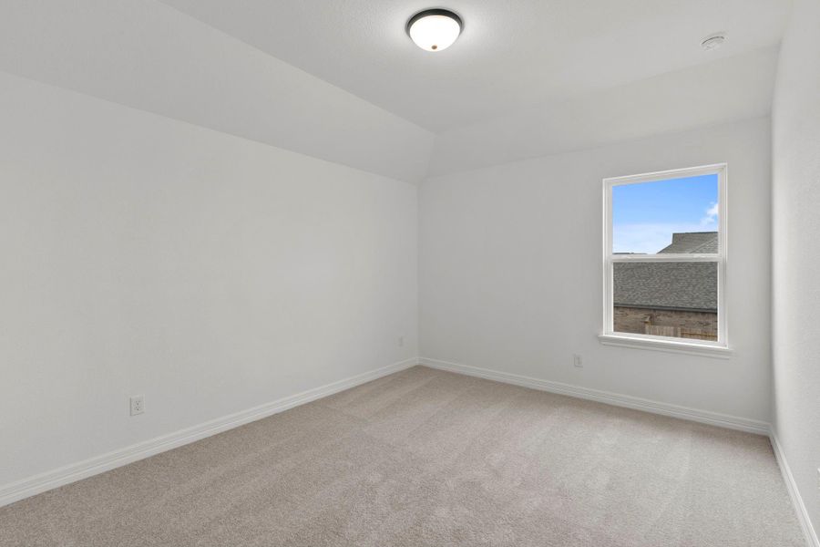 Your secondary bedroom features plush carpet, fresh paint, closet, and a large window that lets in plenty of natural lighting.