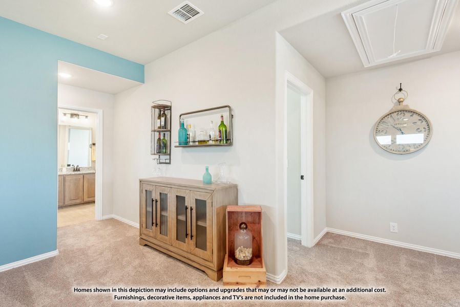 Bonus room with carpet, wood cabinet, wall-mounted bar shelf, and hallway leading to bathroom with teal accent wall Bonus room with carpet, wood cabinet, wall-mounted bar shelf, and hallway leading to bathroom with teal accent wall