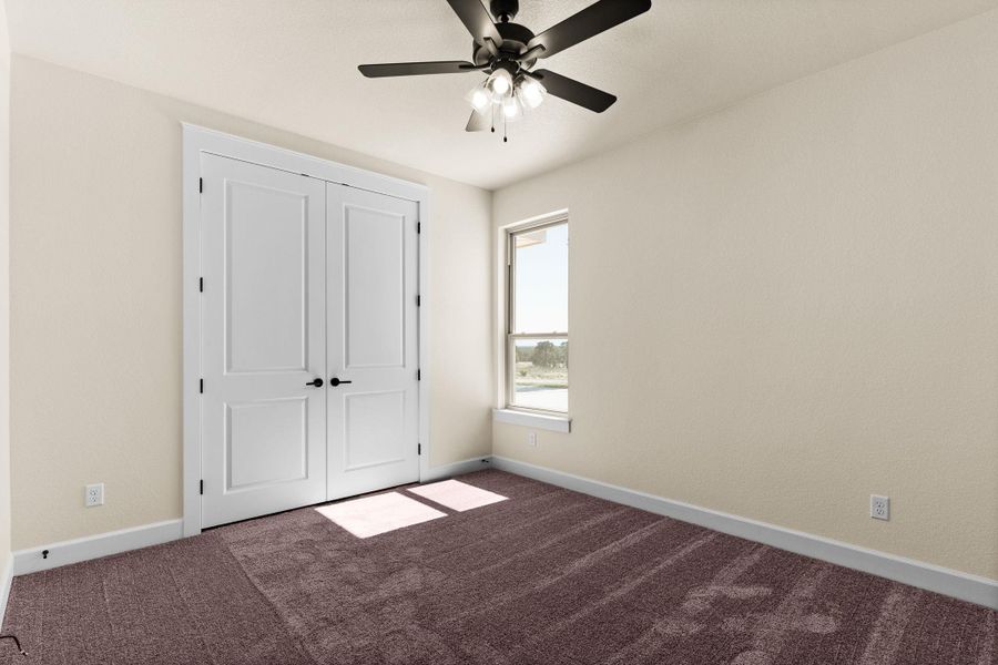Unfurnished bedroom with carpet, a closet, and a ceiling fan Unfurnished bedroom with carpet, a closet, and a ceiling fan