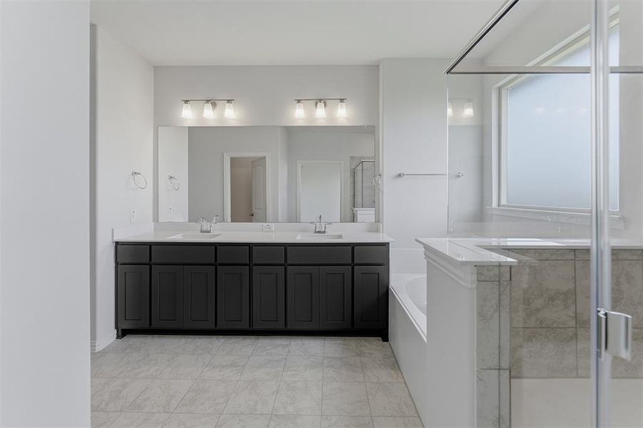 Double vanity with dark wood cabinetry, white countertops, and dual undermount sinks Double vanity with dark wood cabinetry, white countertops, and dual undermount sinks