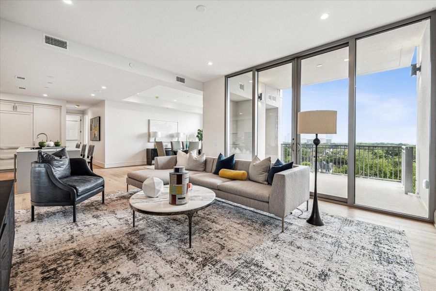 Open living space with expansive floor-to-ceiling windows, providing abundant natural light and sweeping views of the city. The spacious layout features clean architectural lines, recessed lighting, and direct access to a private balcony. Open living space with expansive floor-to-ceiling windows, providing abundant natural light and sweeping views of the city. The spacious layout features clean architectural lines, recessed lighting, and direct access to a private balcony.