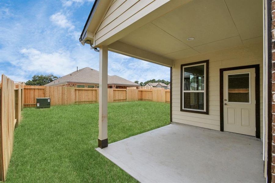 Discover the charm of this spacious backyard featuring a delightful covered patio. With ample room for both play and relaxation, it's the perfect outdoor haven. Tailor this space to your liking with patio furniture, a BBQ pit, and more. The potential for creating your dream outdoor living area is limitless! Sample photo of completed home with same plan. Actual colors and selections may vary.