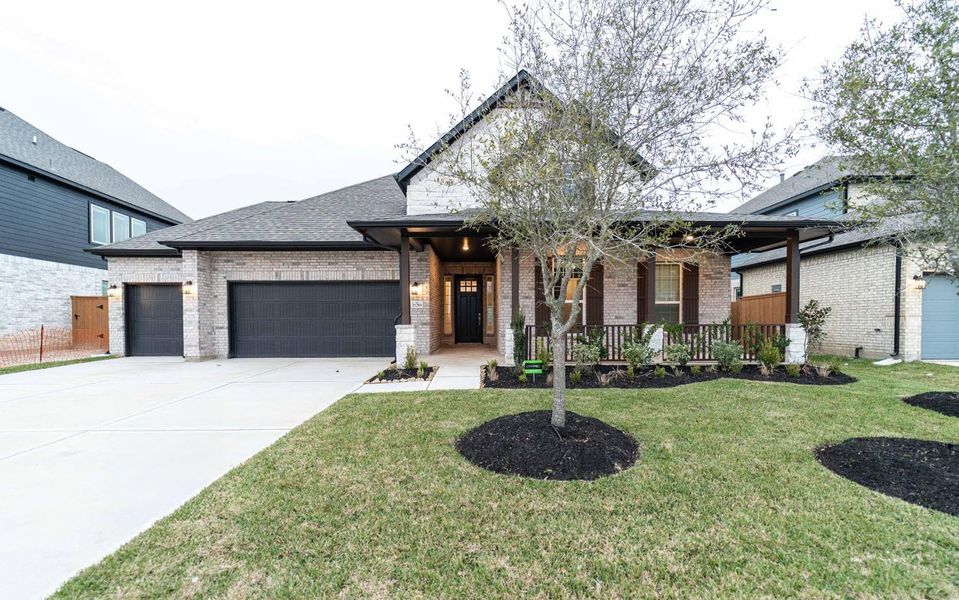 Front exterior of a new home in Marvida, Cypress, TX, highlighting curb appeal (Image 14). Front exterior of a new home in Marvida, Cypress, TX, highlighting curb appeal (Image 14).