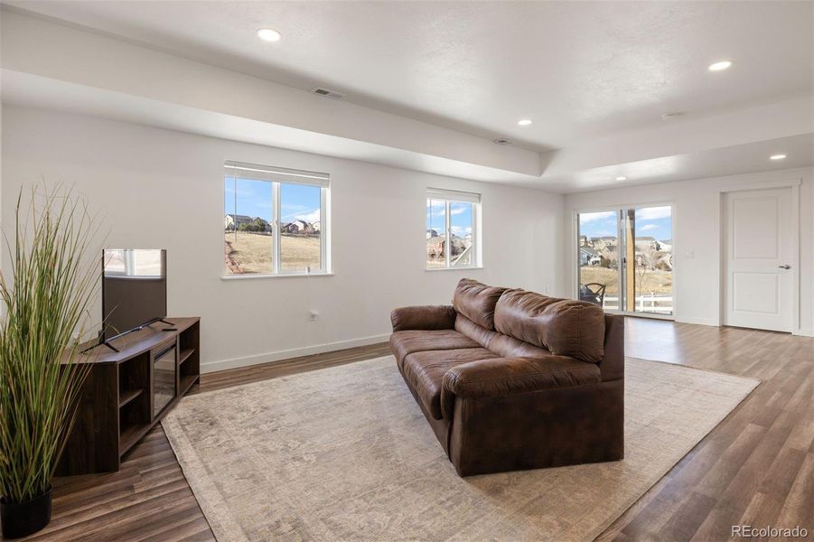 Expansive, newly finished basement living space with 8-foot ceilings.