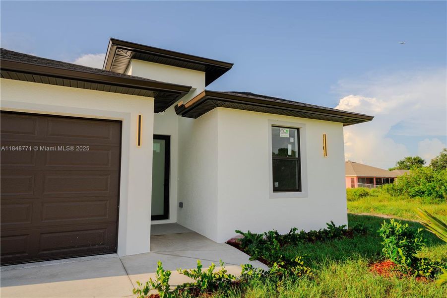 Front exterior of a new home in , Lehigh Acres, FL, highlighting curb appeal (Image 1). Front exterior of a new home in , Lehigh Acres, FL, highlighting curb appeal (Image 1).