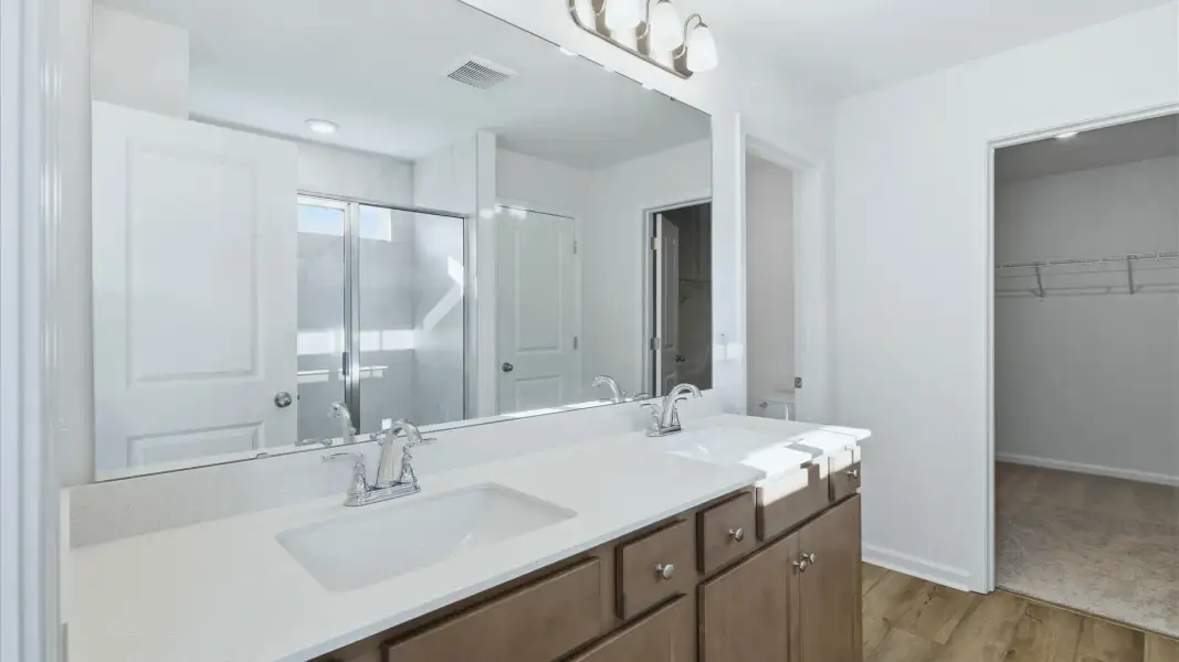 Refresh in the sleek glass shower of the Pritchard’s primary bath
