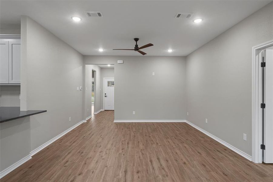 Empty room with wood finished floors, ceiling fan, and recessed lighting