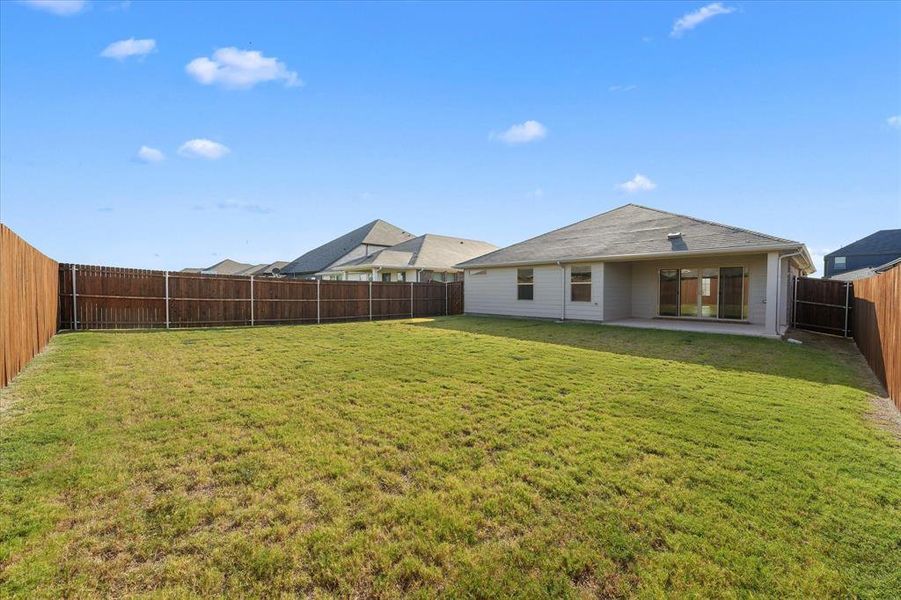 Back of property with a fenced backyard and a patio area Back of property with a fenced backyard and a patio area