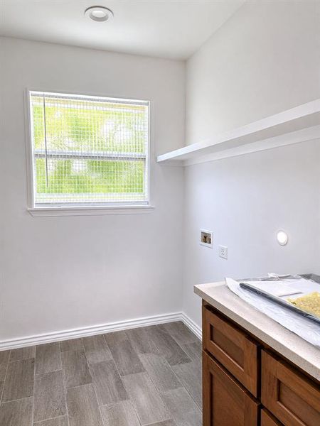 Bright room featuring wood-finish tile flooring, a window with blinds, and recessed ceiling lighting