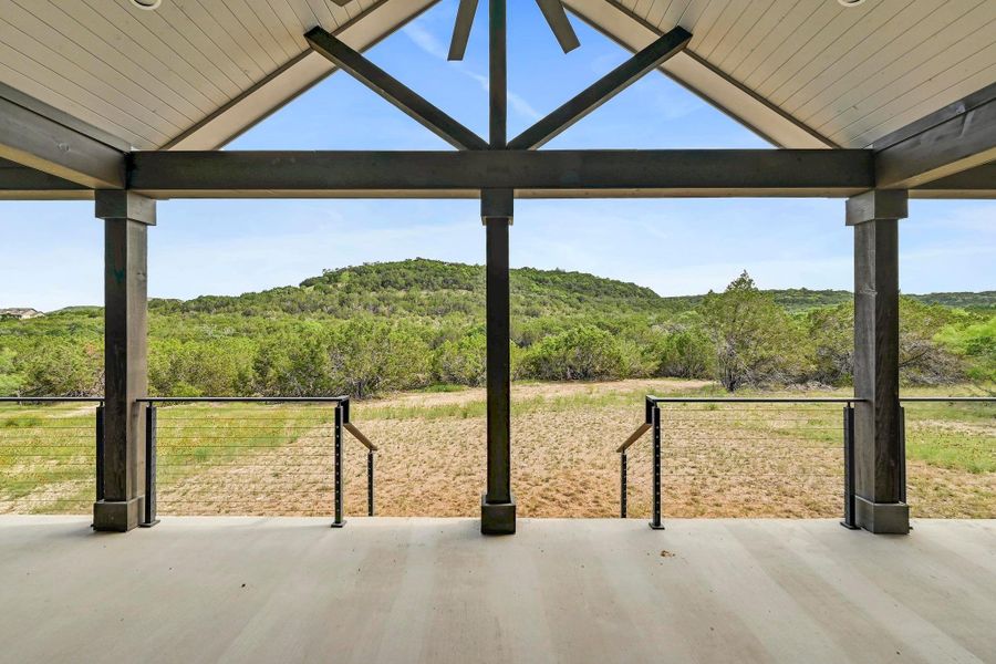 Step outside onto the expansive covered back porch to toast to the epic hill country vistas. Step outside onto the expansive covered back porch to toast to the epic hill country vistas.