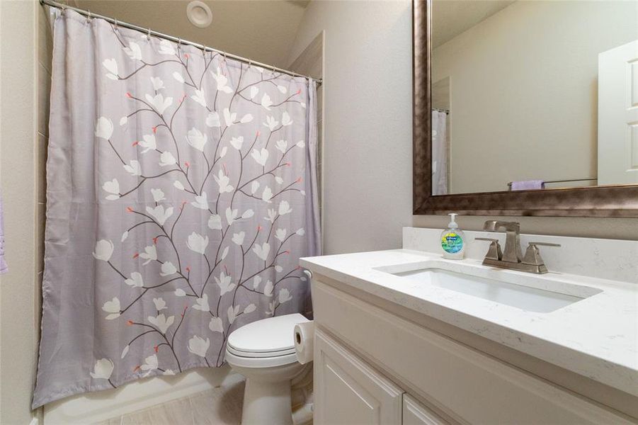 Full bathroom featuring vanity and shower / bath combo with shower curtain