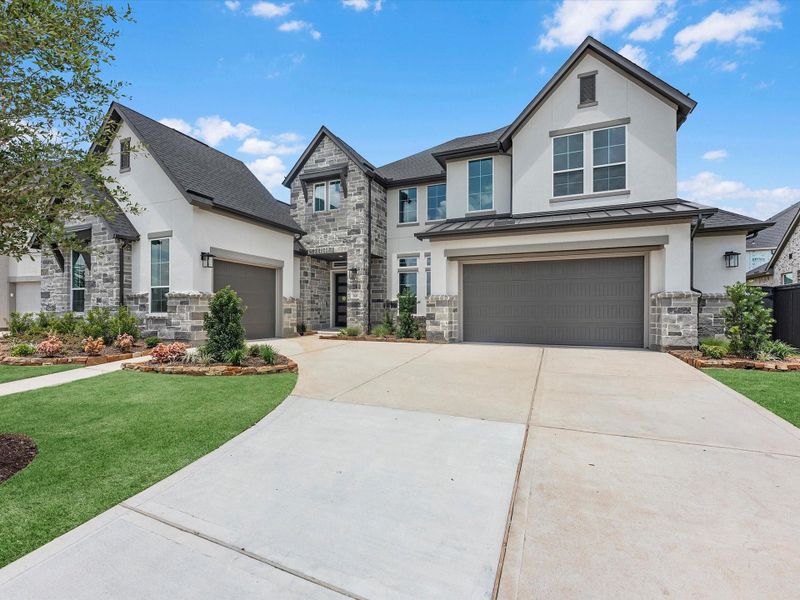 Front exterior of a new home in Harvest Green, Richmond, TX, highlighting curb appeal (Image 1). Front exterior of a new home in Harvest Green, Richmond, TX, highlighting curb appeal (Image 1).