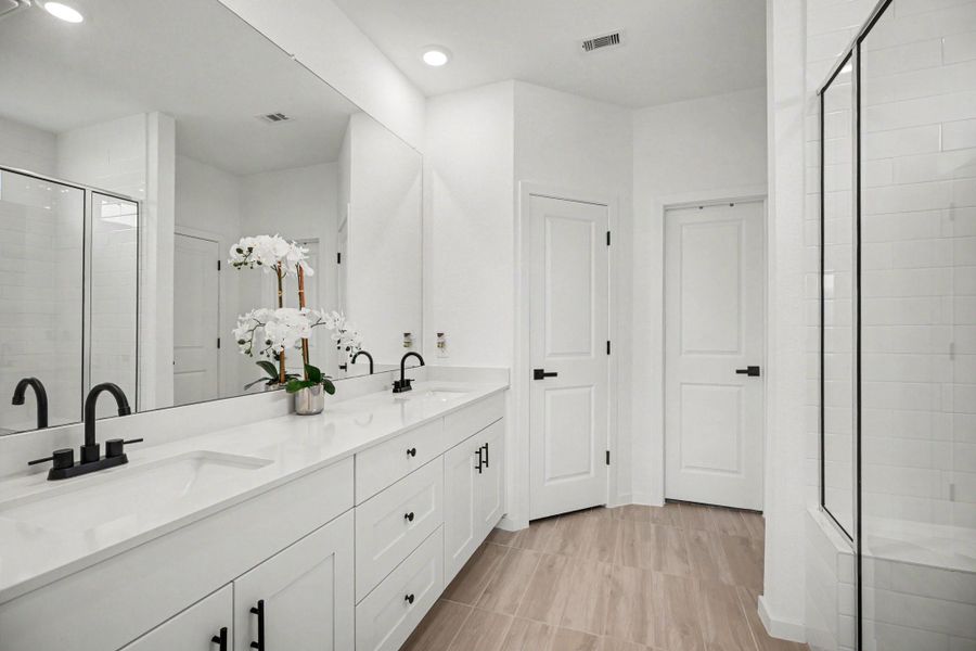 Well-appointed primary bath featuring a dual-sink vanity, expansive mirror, abundant cabinet and drawer storage, and a dedicated linen closet. Well-appointed primary bath featuring a dual-sink vanity, expansive mirror, abundant cabinet and drawer storage, and a dedicated linen closet.