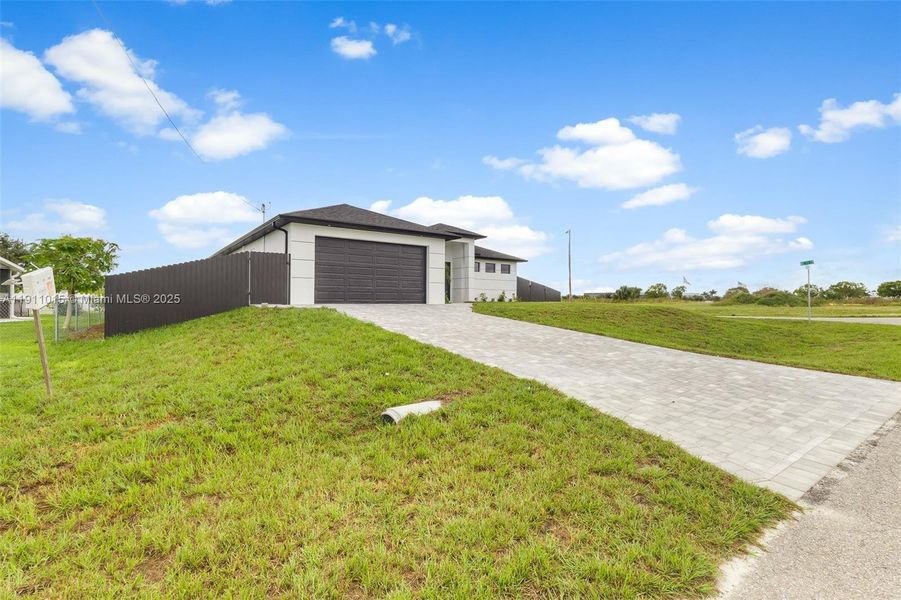 Front exterior of a new home in , Cape Coral, FL, highlighting curb appeal (Image 2). Front exterior of a new home in , Cape Coral, FL, highlighting curb appeal (Image 2).