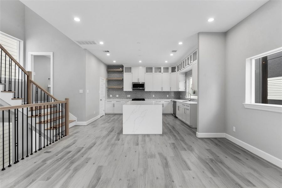 View of kitchen from the dining area with access to the powder room on the landing of the stairs View of kitchen from the dining area with access to the powder room on the landing of the stairs
