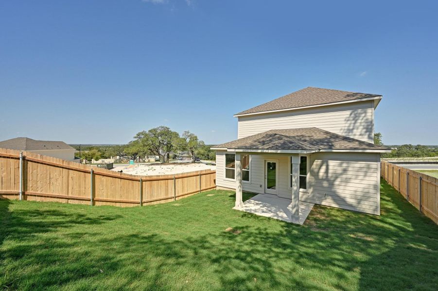 Front exterior of a new home in Creekside at Estancia, Austin, TX, highlighting curb appeal (Image 2).
