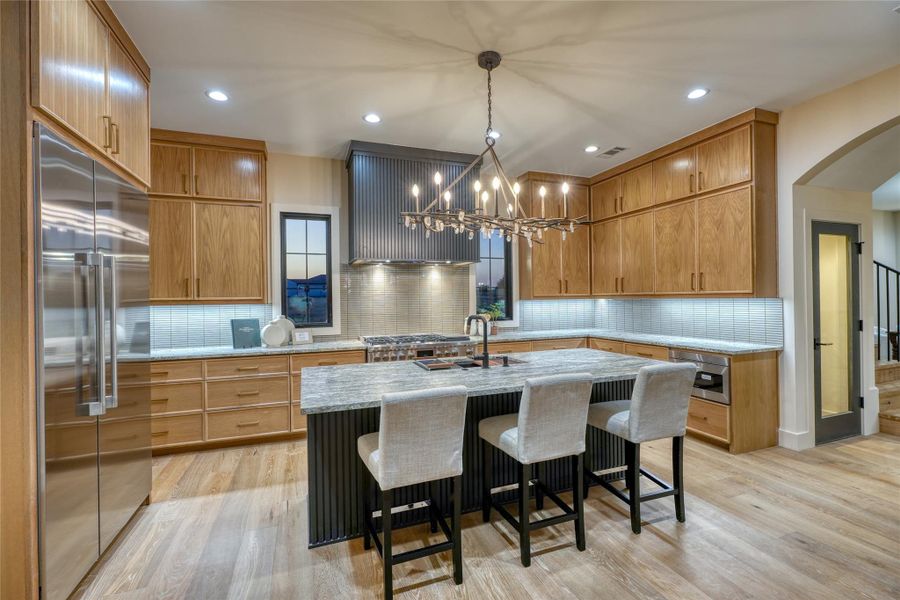 Gorgeous custom chandelier! There is also a large walk-in pantry adjacent to kitchen.