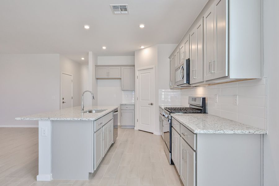 A kitchen with white cabinets. A kitchen with white cabinets.