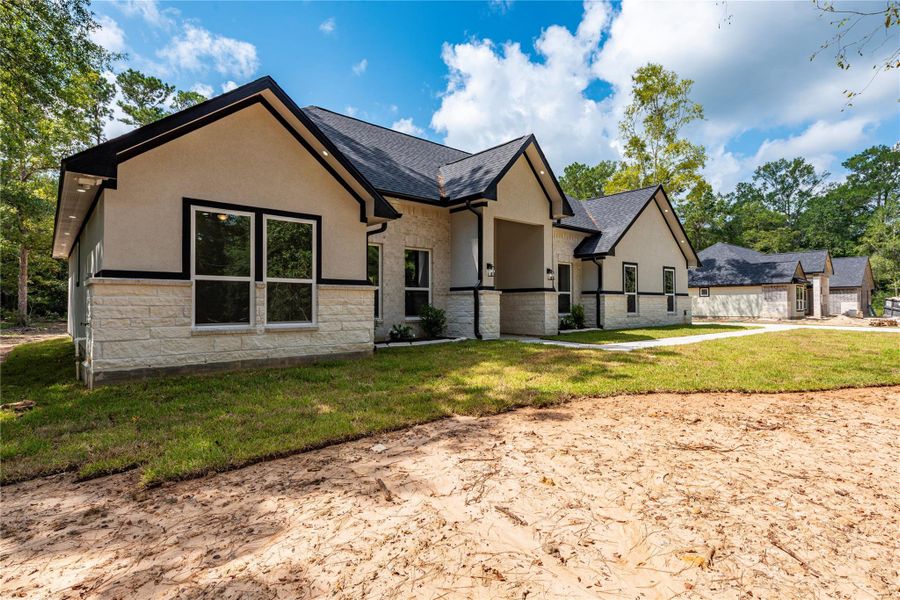 Front exterior of a new home in , Dayton, TX, highlighting curb appeal (Image 23).