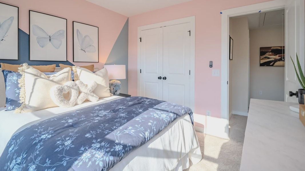 Secondary bedroom with carpet and windows