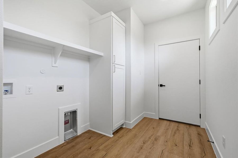 Built in cabinet and shelving with bright windows!