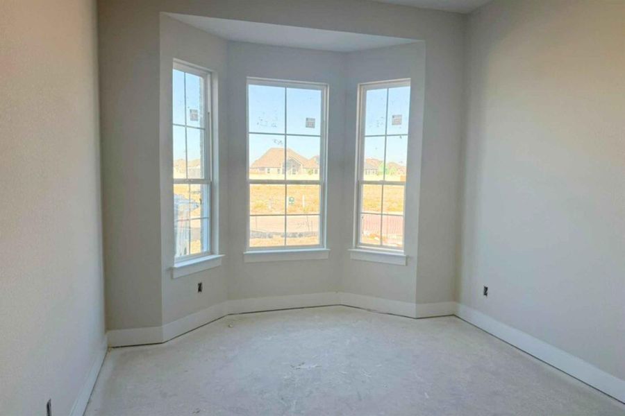 Empty room featuring baseboards