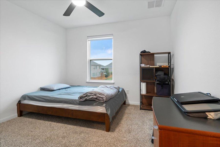 Bedroom with light carpet and ceiling fan