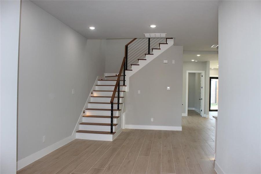 Stairs featuring hardwood / wood-style floors