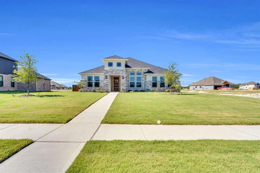 Front exterior of a new home in Ten Mile Creek Estates, DeSoto, TX, highlighting curb appeal (Image 16). Front exterior of a new home in Ten Mile Creek Estates, DeSoto, TX, highlighting curb appeal (Image 16).
