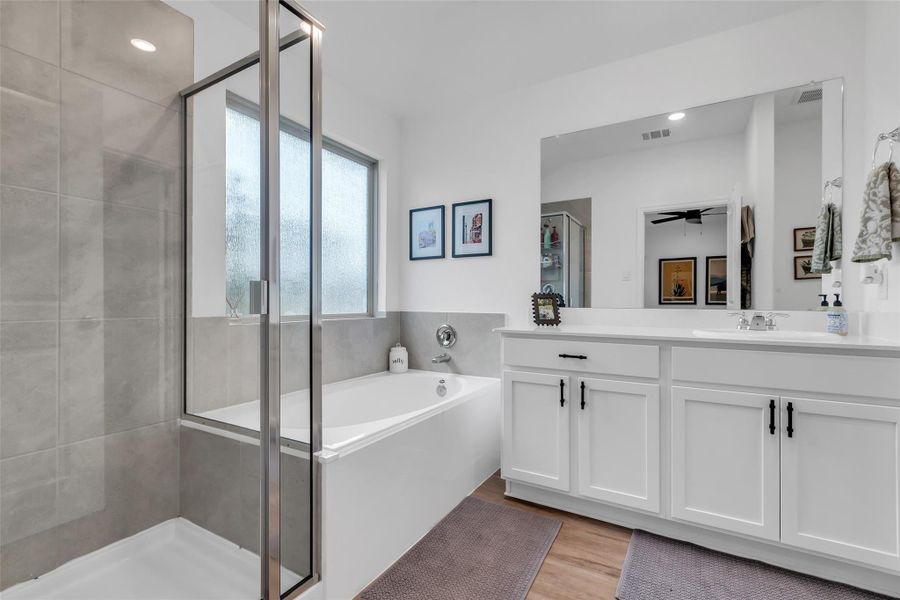 The primary bedroom is ensuite. This large bathroom consist of a walk in shower, soaker tub, sink, vanity area, toilet, and a large walk in closet.
