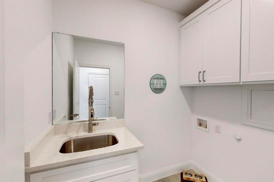 Laundry area featuring sink, cabinets, and hookup for a washing machine