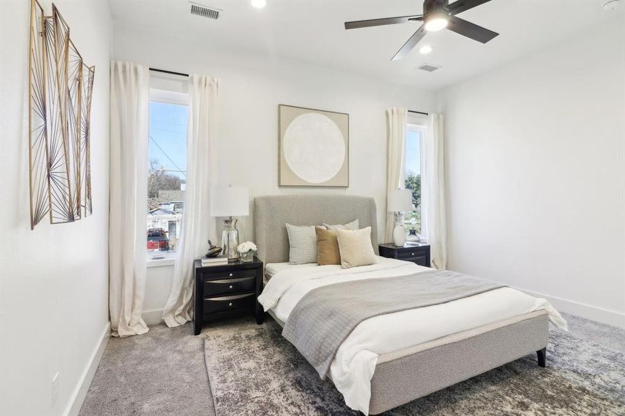 Bedroom featuring ceiling fan and carpet