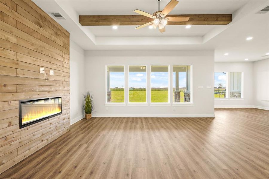 No need to hang pictures in this elegantly designed Living Room, as the quartet of windows overlooking the countryside is living art at its finest. The tray ceiling takes these 10-foot ceilings up to a lofty 11 feet, making the space feel light and bright.