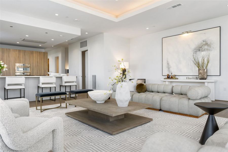 The open-concept living area flows seamlessly into the kitchen, with a conveniently located door just off the kitchen leading to a versatile storage space that can also serve as a spacious walk-in pantry.