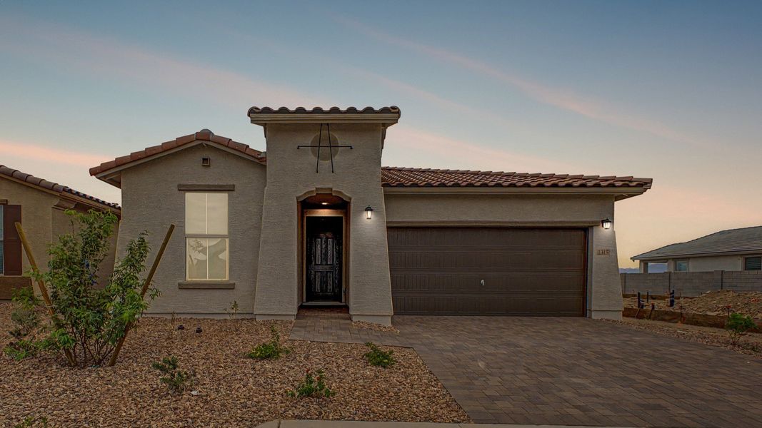 Dusk view of move-in ready single-story Clover home by DRB Homes at Sienna Park, 1315 S. 215th Drive, Buckeye, Arizona 85326. Dusk view of move-in ready single-story Clover home by DRB Homes at Sienna Park, 1315 S. 215th Drive, Buckeye, Arizona 85326.
