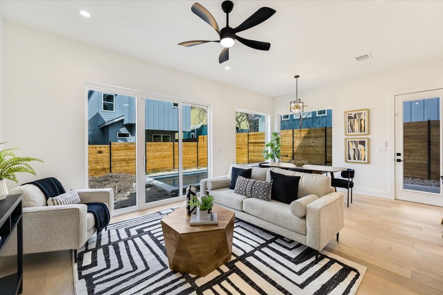 Relaxation redefined. The black architectural ceiling fan adds a sharp, modern contrast to the crisp white walls.