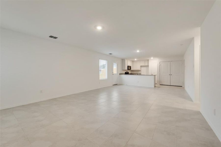 Unfurnished living room featuring light tile patterned floors