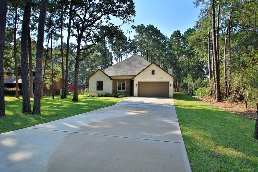 Front exterior of a new home in , Magnolia, TX, highlighting curb appeal (Image 22). Front exterior of a new home in , Magnolia, TX, highlighting curb appeal (Image 22).