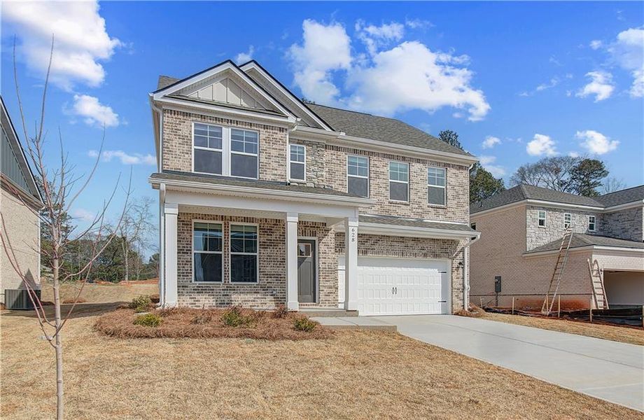 Front exterior of a new home in Bowers Farm, McDonough, GA, highlighting curb appeal (Image 1). Front exterior of a new home in Bowers Farm, McDonough, GA, highlighting curb appeal (Image 1).